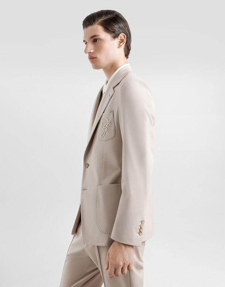 Dolce & Gabbana Einreihige Jacke aus Stretchjersey mit Logostickerei Beige G2TJ6ZFUGS1