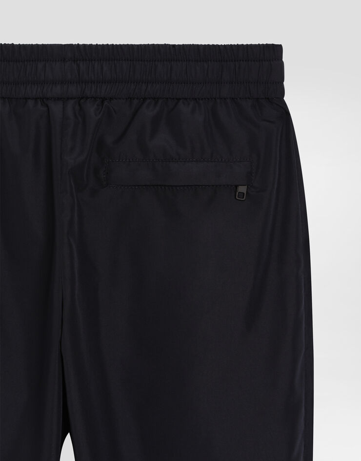 Dolce & Gabbana Pantaloni jogging in nylon con placca logata Blu L44P87FUS0L