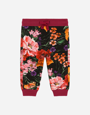 Dolce & Gabbana Jersey jogging pants with floral print over a black background Print L23Q34FI5KS