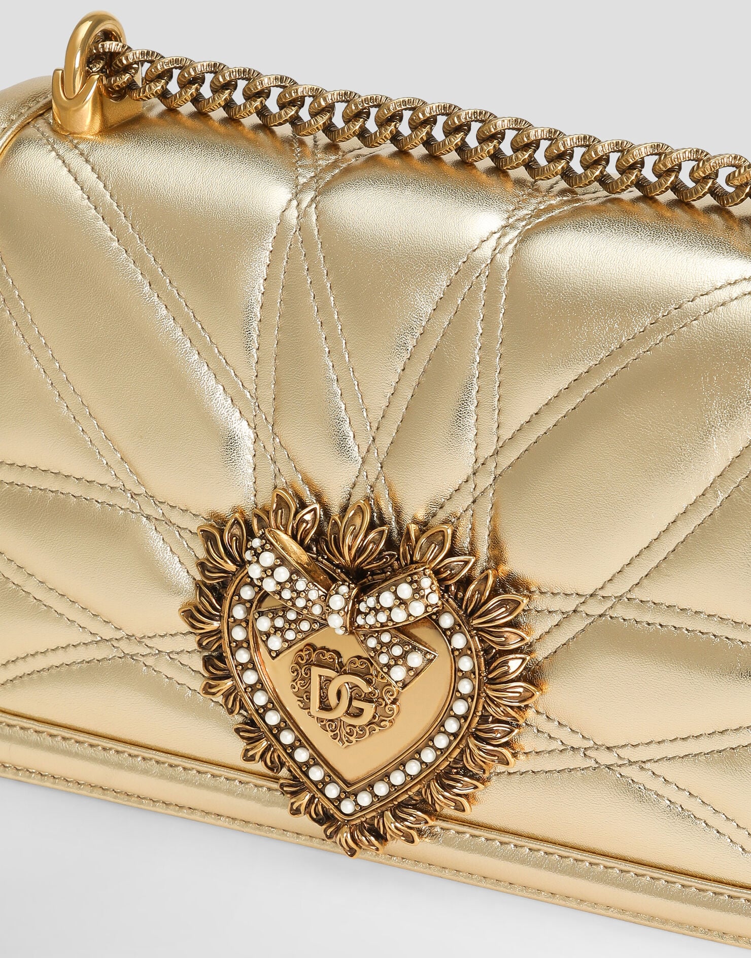 Close-up of the Dolce & Gabbana Devotion Bag heart clasp and quilted leather.