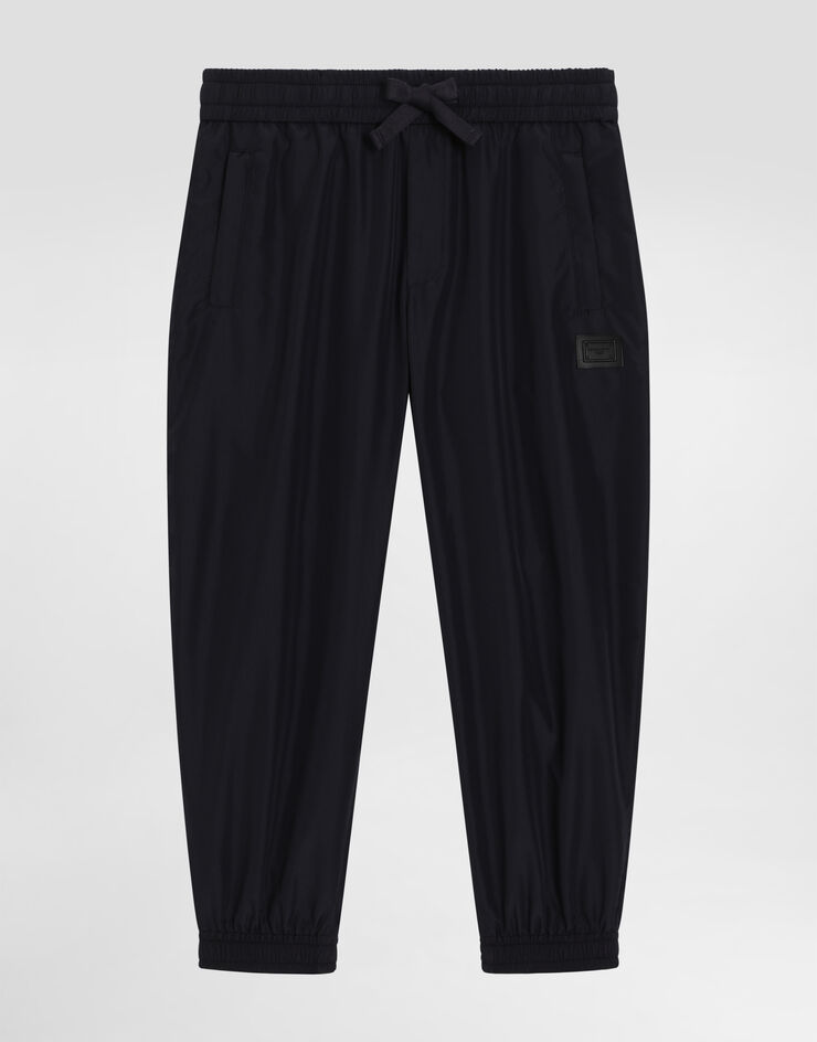 Dolce & Gabbana Pantaloni jogging in nylon con placca logata Blu L44P87FUS0L
