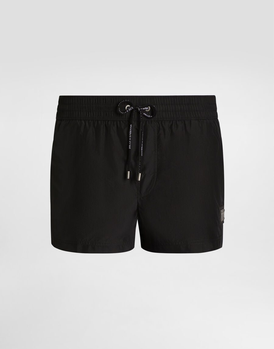 Short swim trunks with branded tag