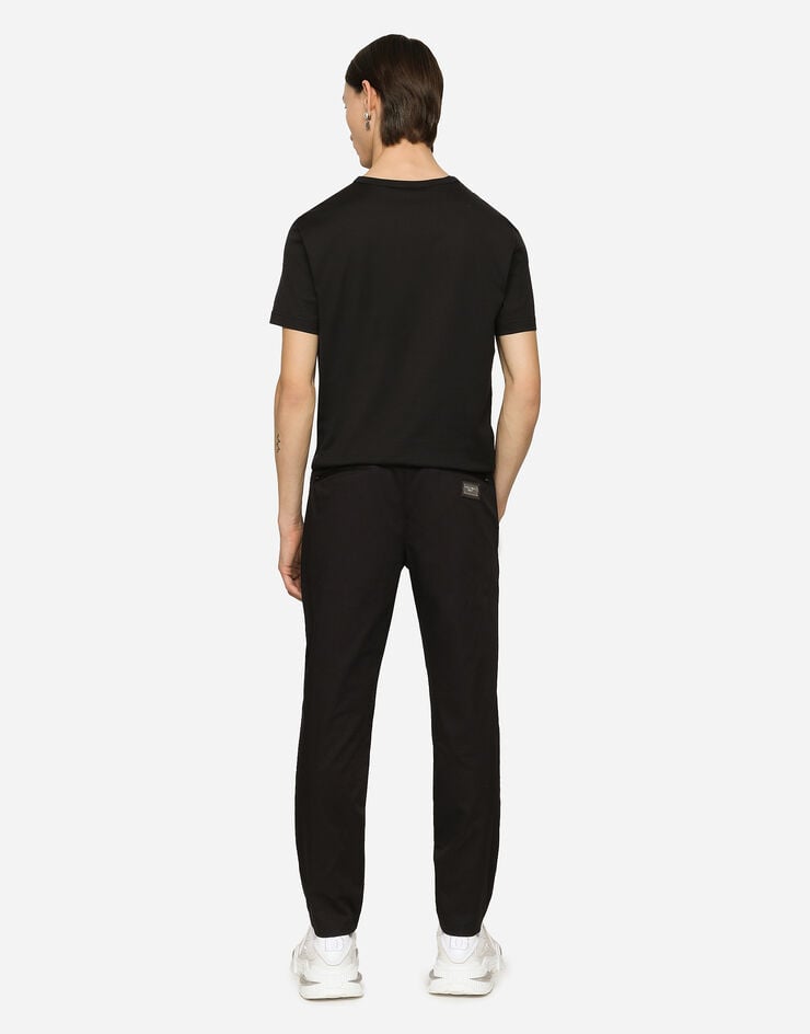 Dolce & Gabbana Pantalon de jogging en coton stretch avec plaquette Bleu GVZAETFUFJR