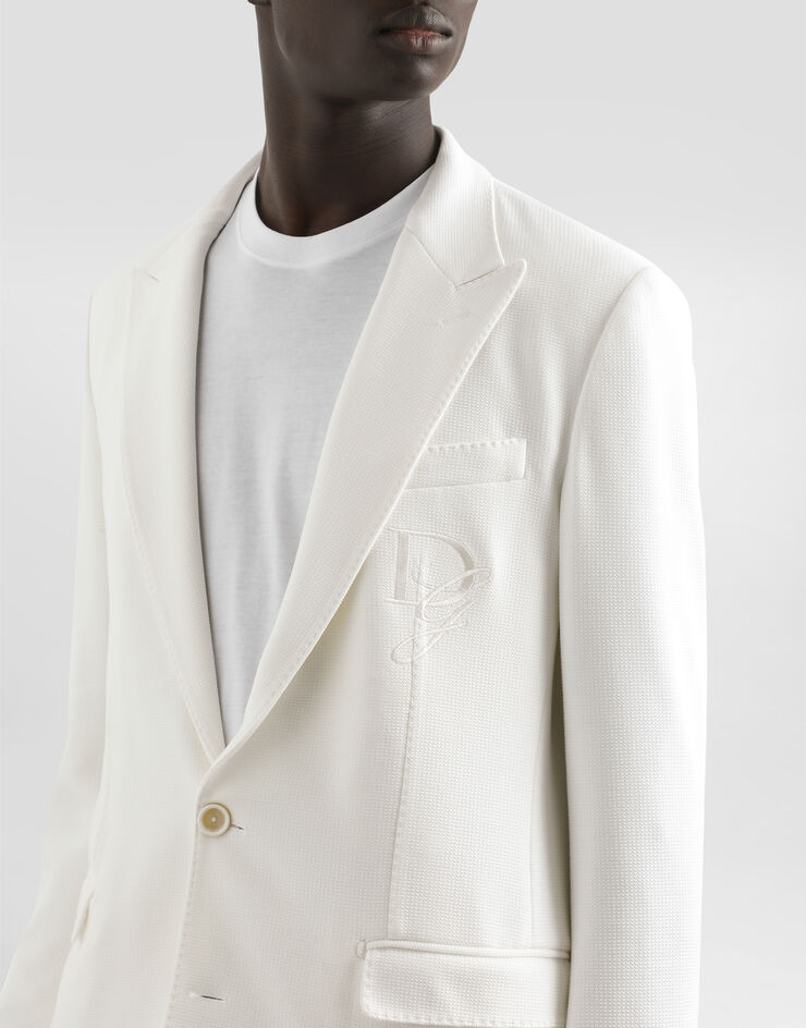 Dolce & Gabbana جاكيت جيرسي مرن بصف أزرار واحد وتطريز شعار أبيض G2TJ5ZGJ070