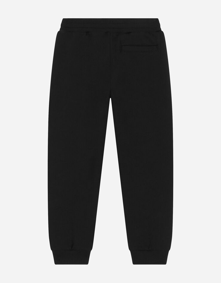 Dolce&Gabbana Pantalón de chándal de punto con logotipo aterciopelado Negro L4JPFEG7K2C