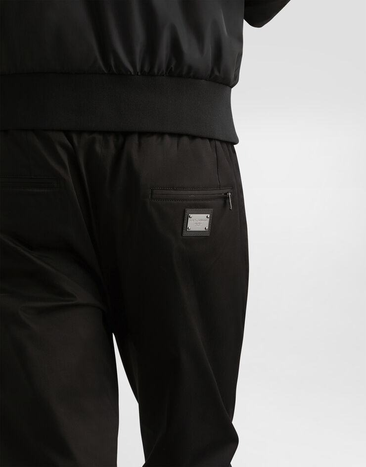 Dolce & Gabbana Jogginghose Baumwollstretch mit Plakette Schwarz GVZAETFUFJR