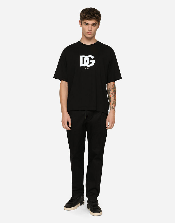 Dolce & Gabbana Pantalon de jogging en coton stretch avec plaquette Noir GYACETFUFIS