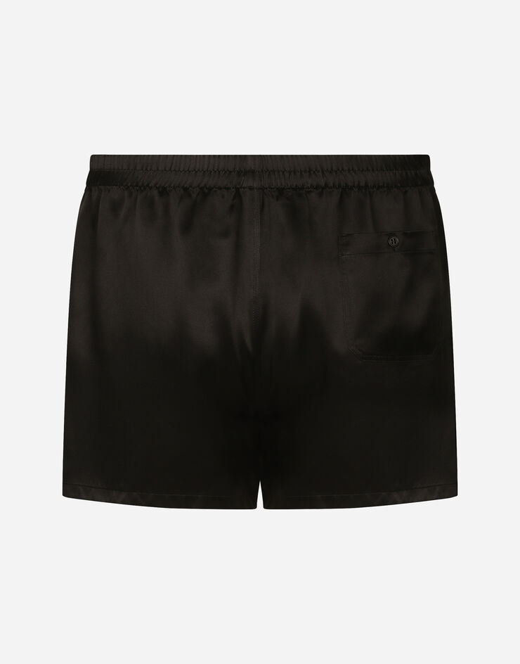 Dolce & Gabbana Shorts aus Seide mit Logoetikett Schwarz M3A05TFU1AU