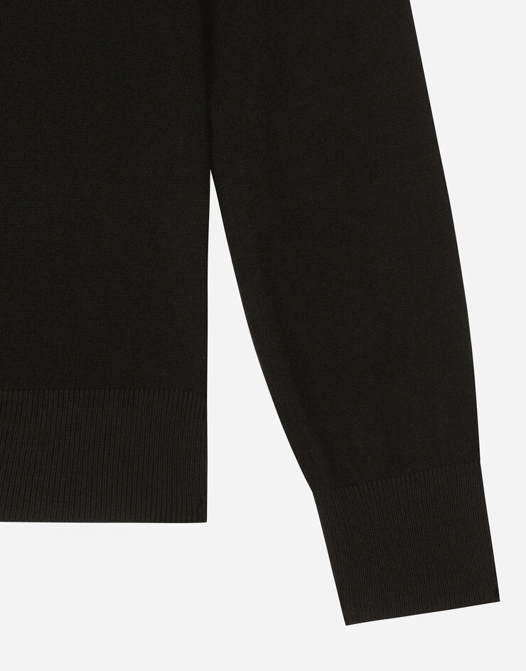 Dolce & Gabbana Jersey de cuello redondo de lana con logotipo DG en relieve Negro GXX01TJFMFC