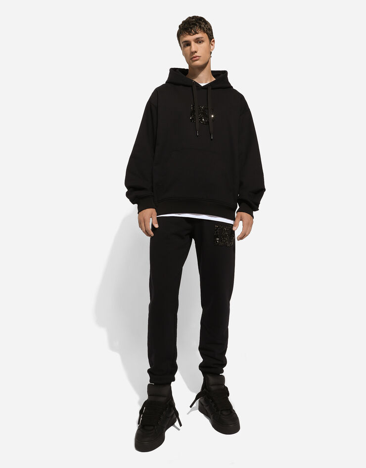 Dolce & Gabbana Sweat-shirt à capuche et écusson DG en strass Noir G9ZU0ZG7K4P