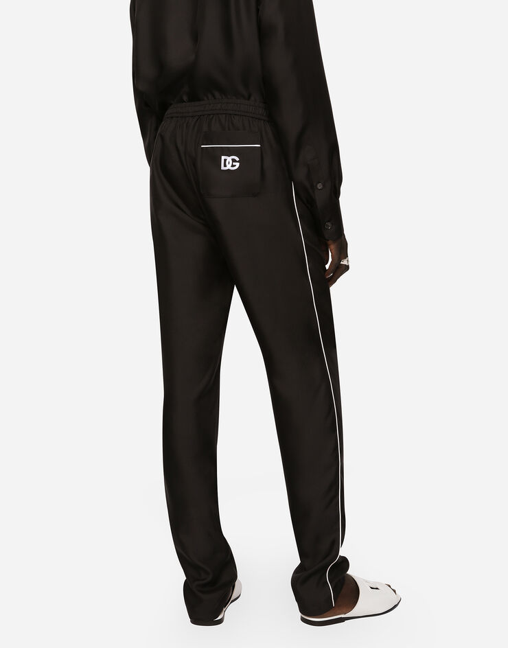 Dolce & Gabbana Pantalon de jogging en soie à écusson broderie DG Noir GVCRAZGF856